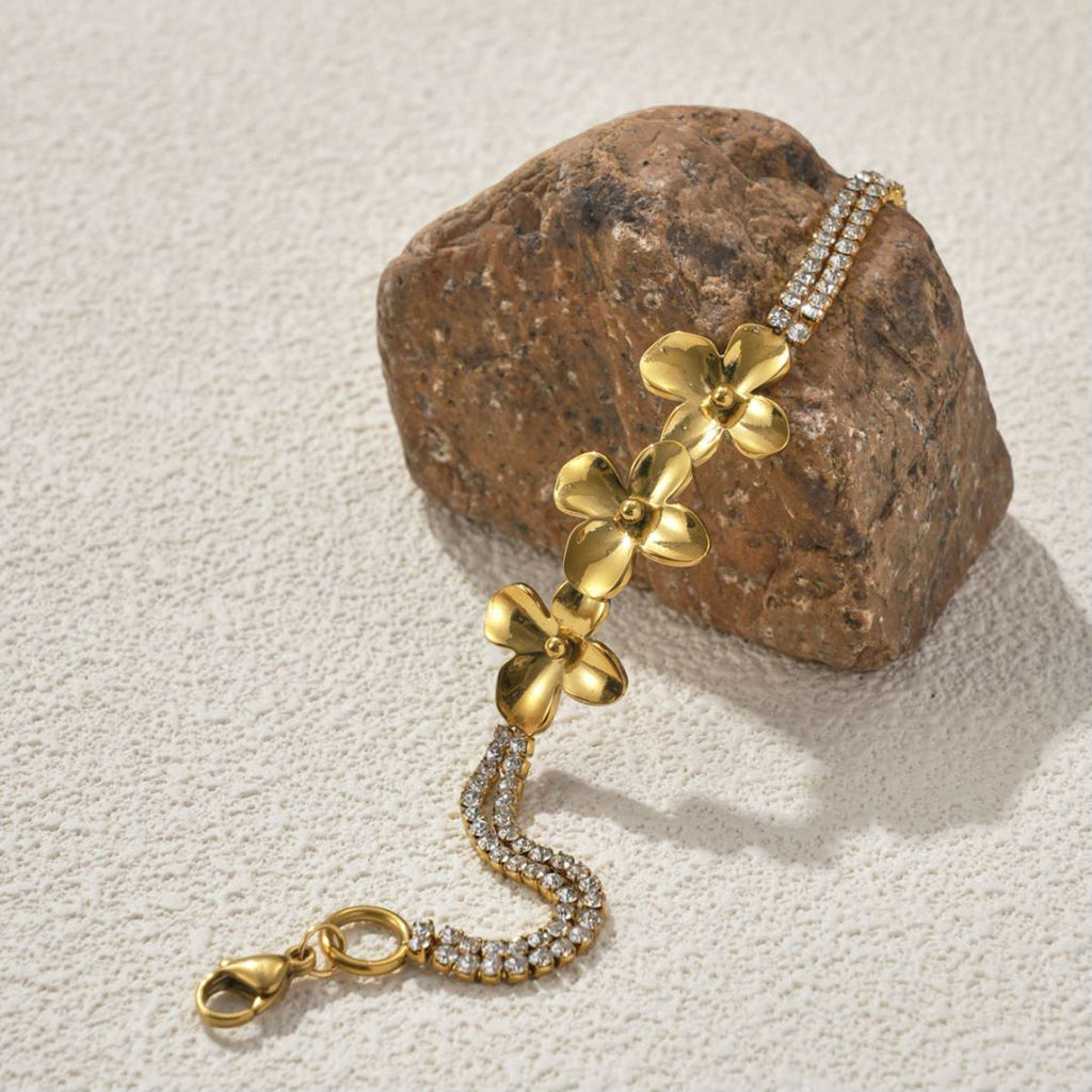18K Gold Plated Stainless Steel Flower Bracelet  on a stone withe background 
