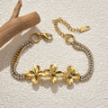 18K Gold Plated Stainless Steel Flower Bracelet on a plan background 