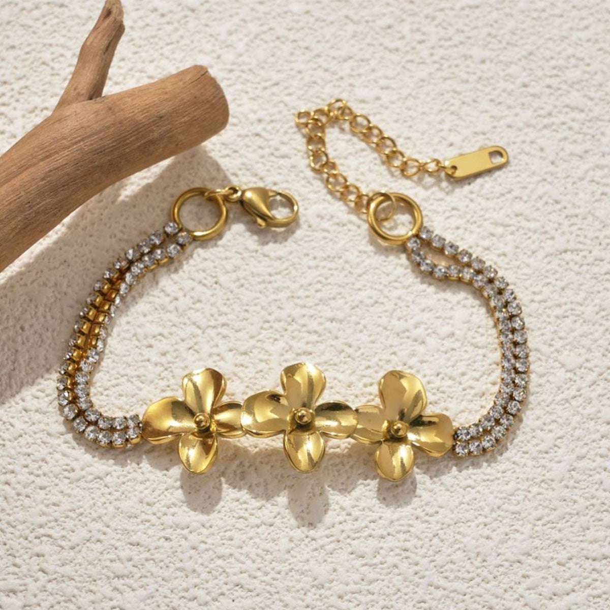 18K Gold Plated Stainless Steel Flower Bracelet on a plan background 