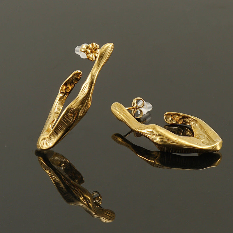 18K Gold plated Titanium Steel Irregular Wood Texture Earrings on a dark background 